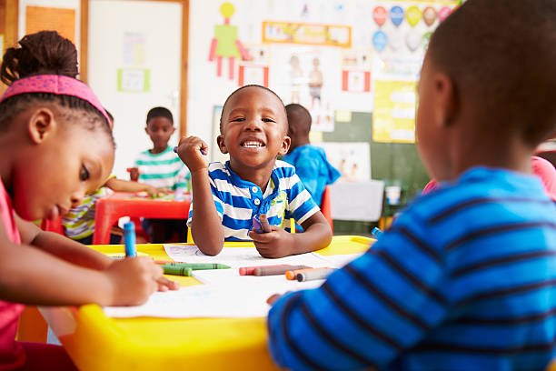 Home preschool class in south africa, boy looking to camera